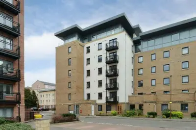 a large apartment building in the middle of a street at Modern Room in a Shared Flat near Haymarket in Edinburgh