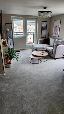a living room with a couch and a table at Modern Room in a Shared Flat near Haymarket in Edinburgh