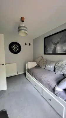 a bedroom with a large bed in a room at Cosy 2 bed home Glasgow South in Cathcart
