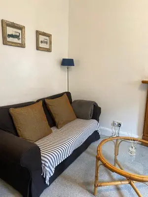 a living room with a couch and a table at 1 Bed Flat Near Edinburgh Castle in Edinburgh