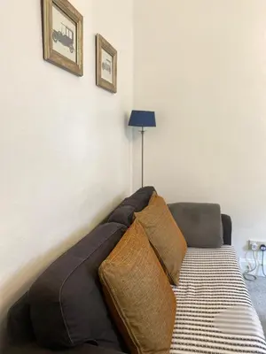 a bed with pillows on it in a room at 1 Bed Flat Near Edinburgh Castle in Edinburgh