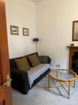 a living room with a couch and a coffee table at 1 Bed Flat Near Edinburgh Castle in Edinburgh