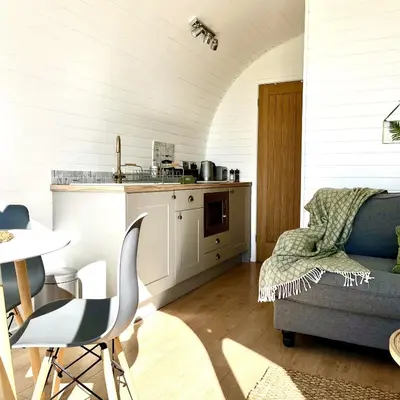 a kitchen with a couch and a table in a room at Heather Pod in Perth