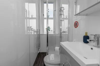 a white bathroom with a toilet and a sink at Free Parking - City Centre - Stunning Views - Great Location in Edinburgh