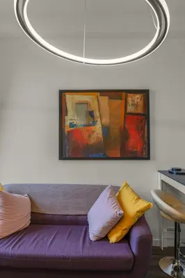 a living room with a purple couch and a painting at Free Parking - City Centre - Stunning Views - Great Location in Edinburgh