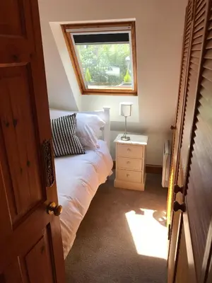 a small bedroom with a bed and a window at STYLISH APARTMENT with PRIVATE ROOF TERRACE in Edinburgh