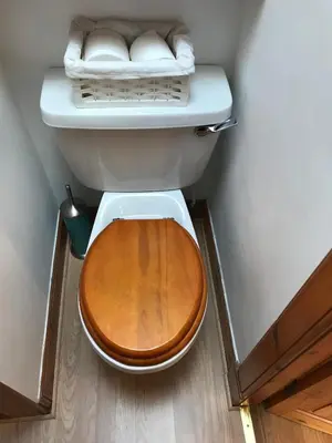 a toilet with a wooden seat in a bathroom at STYLISH APARTMENT with PRIVATE ROOF TERRACE in Edinburgh