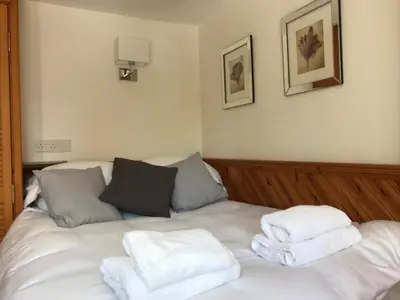 a room with a bed with towels on it at STYLISH APARTMENT with PRIVATE ROOF TERRACE in Edinburgh