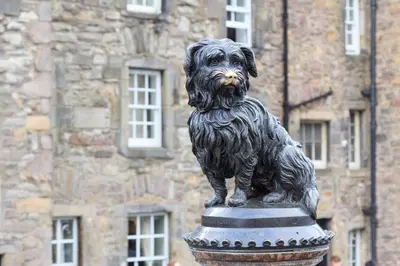 a statue of a dog in front of a building at STYLISH APARTMENT with PRIVATE ROOF TERRACE in Edinburgh