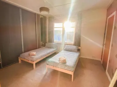 a small room with two beds and a window at 20min to Edinburgh City Centre Scotland Gateway in Cowdenbeath
