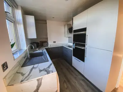 a kitchen with a sink and a refrigerator at 20min to Edinburgh City Centre Scotland Gateway in Cowdenbeath