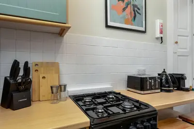 a stove top oven sitting on a counter in a kitchen at Charming and Cosy Getaway in Cambusbarron