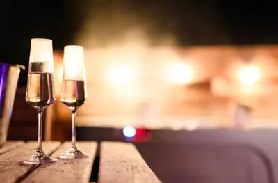 two glasses of wine sitting on a table at Barnharrow Holiday Pods in Newton Stewart