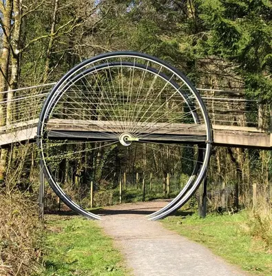 a bike wheel sitting under a bridge on a path at Barnharrow Holiday Pods in Newton Stewart
