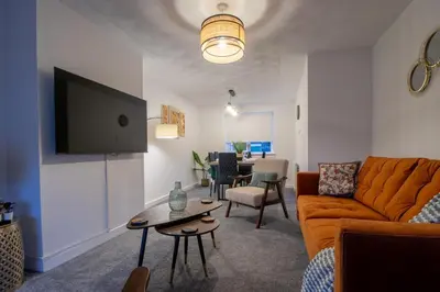 a living room with a couch and a table at Boswell House - Modern 3 Bed House East Kilbride Close to Motorway in East Kilbride