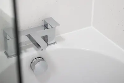 a bathroom door with a metal door knob at Sonas Apartment in Greenock