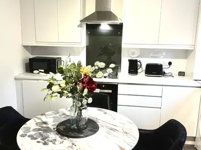 a vase of flowers on a table in a kitchen at Summerlee Gateaway in Coatbridge