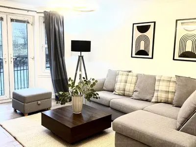 a living room with a couch and a coffee table at Summerlee Gateaway in Coatbridge