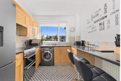 a kitchen with a washer and dryer in it at Grangeburn Residence - 2 bedroom home with parking in Falkirk