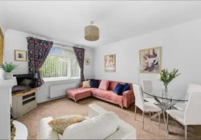 a living room with a couch and a table at Grangeburn Residence - 2 bedroom home with parking in Falkirk