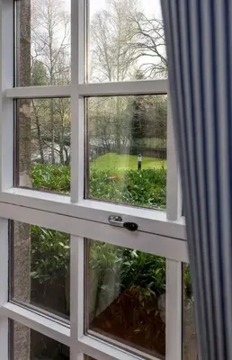 a window with a view of a golf course at The Mill Retreat in Stirling