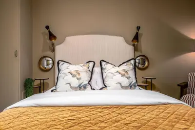 a bedroom with a bed with two pillows at The Mill Retreat in Stirling