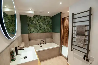 a bathroom with a bath tub and a sink at 12 & 14 On the Hill Aberfoyle, twin holiday cottages in Scenic Loch Lomond & Trossachs National Park in Aberfoyle