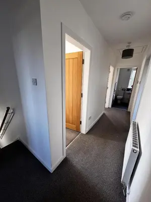 an empty room with a door and a hallway at Loch Ore View in Kelty
