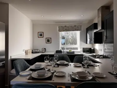 a table with glasses and plates on it in a kitchen at Loch Ore View in Kelty