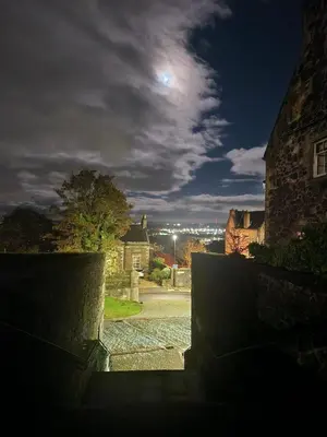 a view of a street at night with the moon at Foresters 4 Bedroom Apartment in Cambusbarron