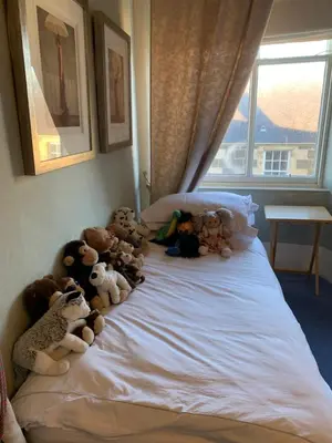 a group of stuffed animals sitting on a bed at Foresters 4 Bedroom Apartment in Cambusbarron