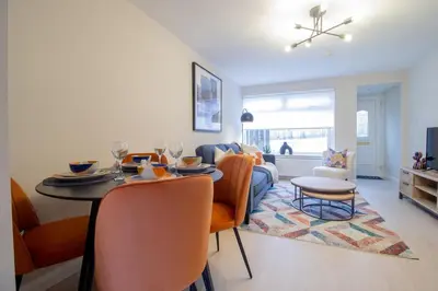 a living room with a table and a couch at Hawick Apartment- 2-Bed in Coatbridge, Mins from Motorway to Glasgow in Old Monkland