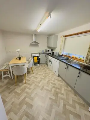 a kitchen with a table and a dining room at Modern & Cosy 3 Bedroom Inverkeithing home- Ideal for Edinburgh Dunfermline & St Andrews with Free Parking in Inverkeithing