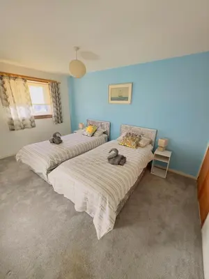 two beds in a room with blue walls at Modern & Cosy 3 Bedroom Inverkeithing home- Ideal for Edinburgh Dunfermline & St Andrews with Free Parking in Inverkeithing