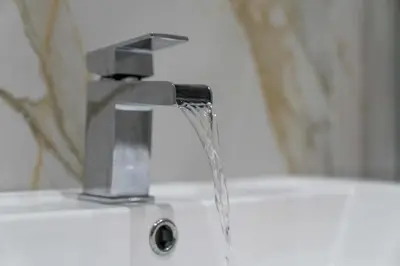 a water faucet with water coming out of it at Paisley Road Courtyard in Glasgow