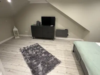a bedroom with a bed and a flat screen tv at Caplawhead in Armadale