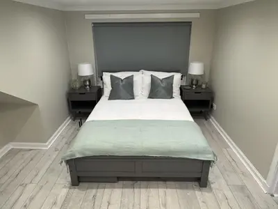a bedroom with a large bed with two night stands at Caplawhead in Armadale