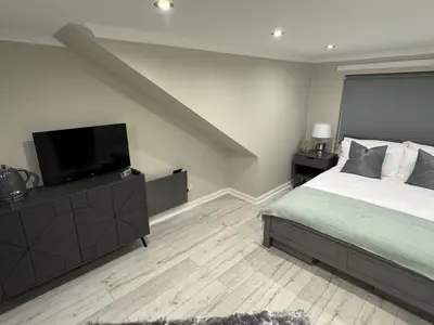 a bedroom with a bed and a flat screen tv at Caplawhead in Armadale
