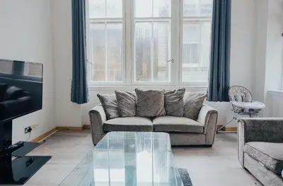 a living room with a couch and a glass table at 2 bed Renfield st City Center in Glasgow