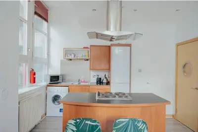 a kitchen with a counter and a sink and a refrigerator at 2 bed Renfield st City Center in Glasgow