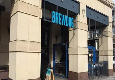 a large building with a blue sign on it at Flat in Central Edinburgh Old town in Edinburgh