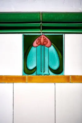 a stained glass window with an umbrella on a shelf at Swan Cove Apartment Gourock in Gourock