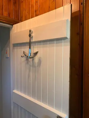 a wall with a shelf with a surfboard on it at Couples Unique Stay in Bowling Club newly upgraded in Forteviot