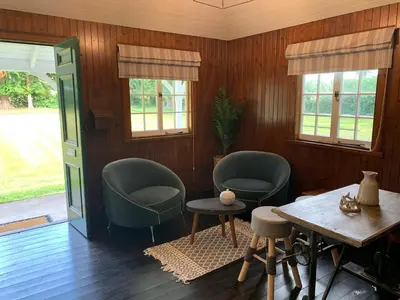 a living room with two chairs and a table at Couples Unique Stay in Bowling Club newly upgraded in Forteviot