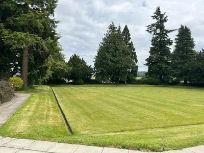 a large grass field with trees in the background at Couples Unique Stay in Bowling Club newly upgraded in Forteviot
