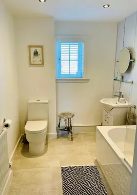 a bathroom with a toilet and a sink and a tub at A 2 Bedroom flat in Culross home of Outlander in Culross