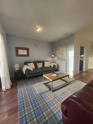a living room with a couch and a coffee table at The Wee House -Coorie Doon Stays in Troon