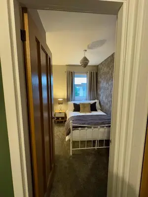 a bedroom with a bed and a window at Cochrane House in Stirling