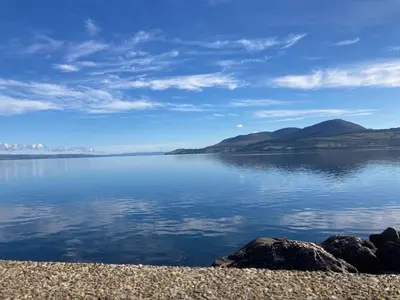 a view of a large body of water with mountains at Holiday home, Carradale in Carradale