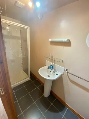 a bathroom with a sink and a shower at Beachview Cottage Co. Antrim in Cushendun